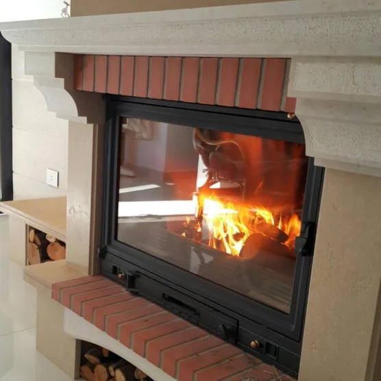 Limestone fireplace surround with a brick-lined firebox